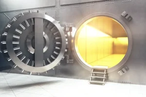 A bank vault opened with gold light shining through the opening