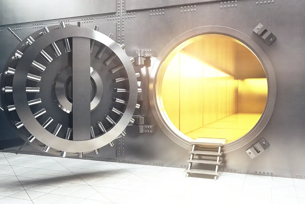 A bank vault opened with gold light shining through the opening