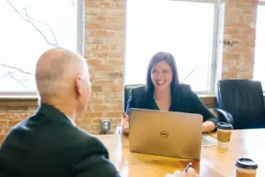Two people in a conference room discussing options for dividend life insurance policies