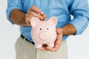 a professional putting his money into a personal piggy bank