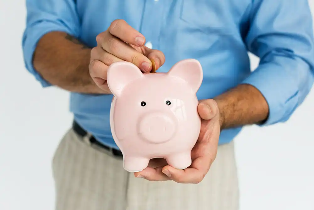 a professional putting his money into a personal piggy bank