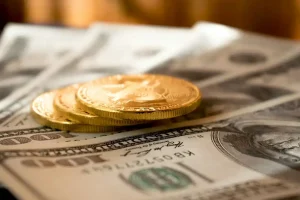 Gold coins and U.S. dollar bills.
