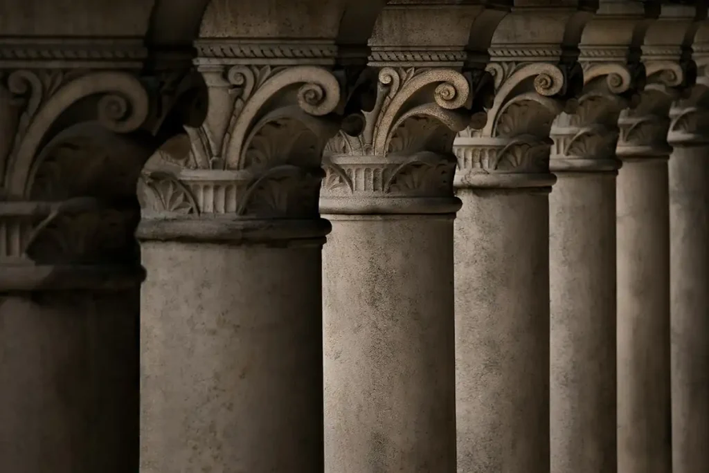 A colonnade of seven stone pillars