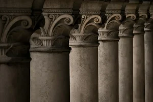 A colonnade of seven stone pillars