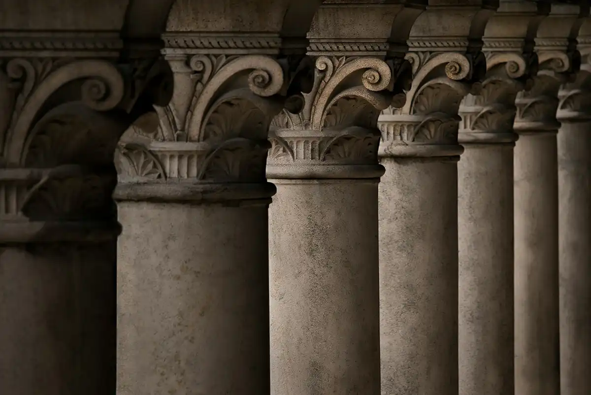 A colonnade of seven stone pillars