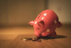 A piggy bank and some gold coins.